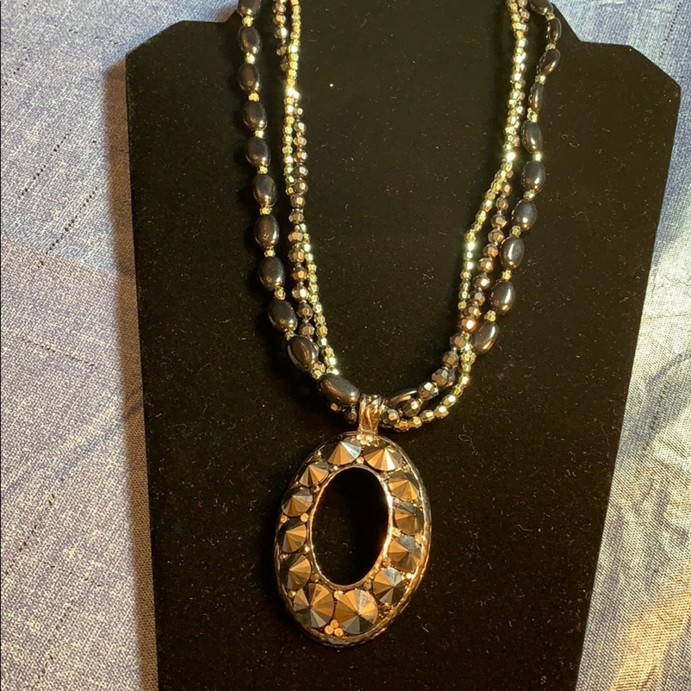 3 strand necklace with large medallion.